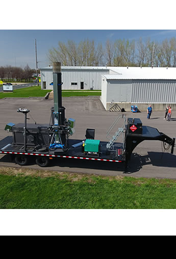 Mobile P50-SC8 incinerator and support equipment on a fifth-wheel lowboy trailer.